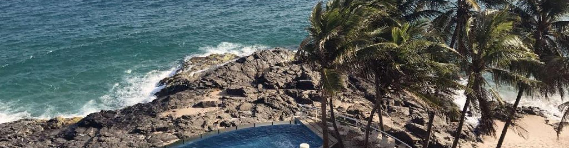 Scenic coastal view of Rio Vermelho at sunset